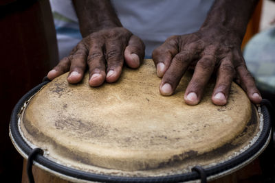 Hands of a musician playing percussion in presentation. 