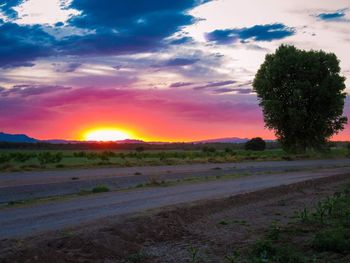 Scenic view of field against sky during sunset