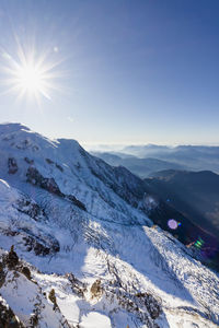 Scenic view of mountains against clear sky during winter