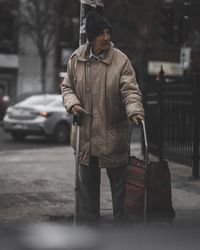 Full length of man looking at city street