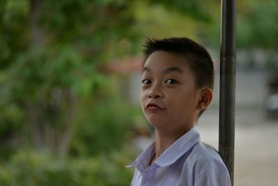 Portrait of boy making face outdoors