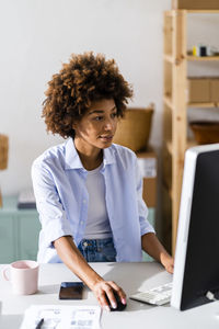 Businesswoman using desktop while working at studio