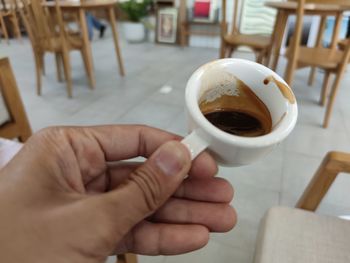 Cropped image of hand holding coffee cup