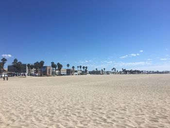 Panoramic view of people on beach against clear sky