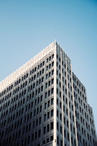 Low angle view of modern building against clear blue sky