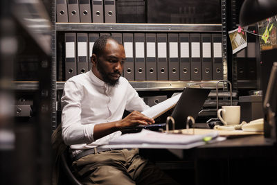 Young man using laptop at office