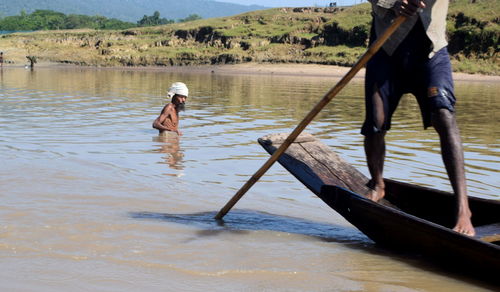 Men standing in water