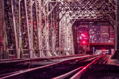 Illuminated road seen through car windshield at night