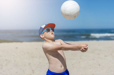 Person wearing sunglasses against sky at beach