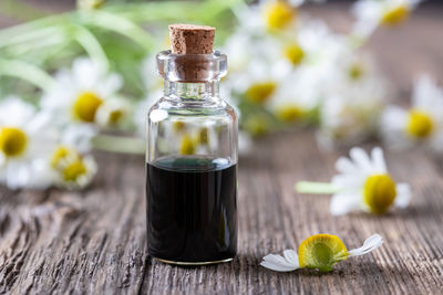 Close-up of glass of bottle on table