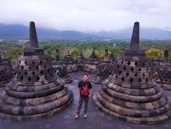 Portrait of young man standing at borobudur temple