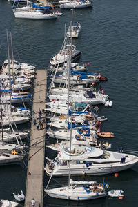 High angle view of sailboats moored at harbor