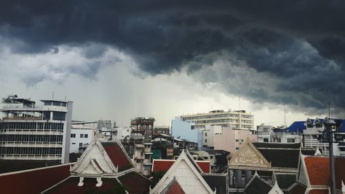 View of town against cloudy sky