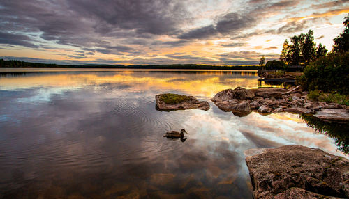 Scenic view of lake against sky during sunset
