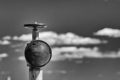 Close-up of electric lamp against sky