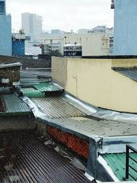 High angle view of houses against buildings in city