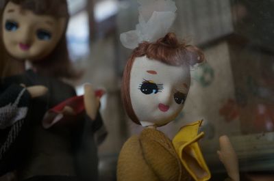 Antique dolls seen through glass window