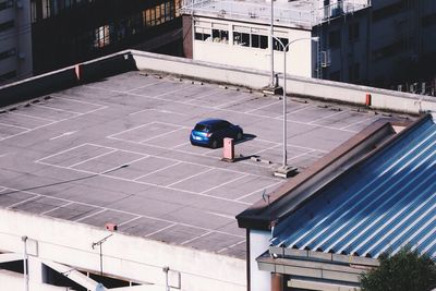 High angle view of car parked in parking lot of building terrace