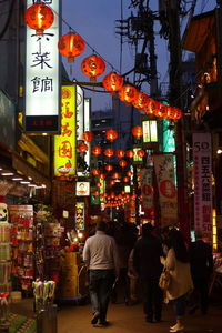 People at illuminated city at night