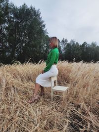 Woman sitting on field