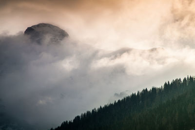 Scenic view of mountains against cloudy sky