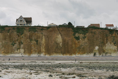 Houses on landscape against sky