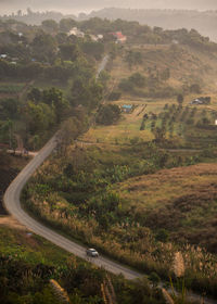 High angle view of road amidst trees and landscape