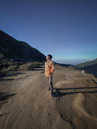 Full length of man standing on land against sky