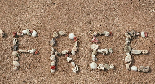 High angle view of text on sand