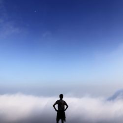 Silhouette of woman standing against sky
