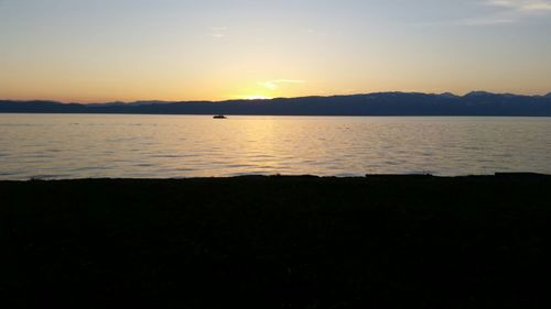 Scenic view of lake at sunset