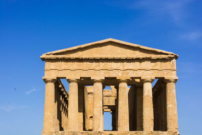 Low angle view of old temple against blue sky