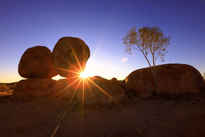 Rock formation on rocks against sky during sunset