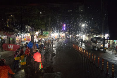 People walking on street at night