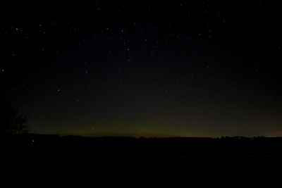 Scenic view of silhouette landscape against sky at night
