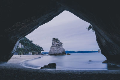 Scenic view of sea seen through cave