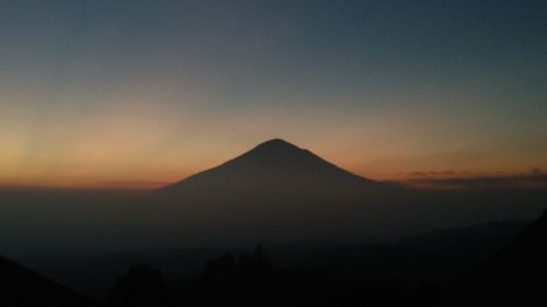 Scenic view of silhouette mountains against sky during sunset