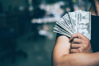 Close-up of hand holding paper