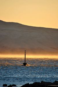 Scenic view of calm sea at sunset