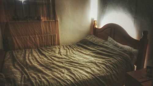 Low section of person relaxing on bed at home