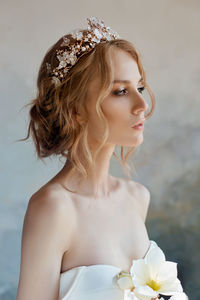 Close-up of bride looking away standing by wall