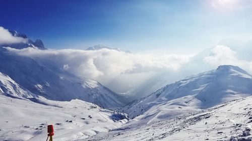 Scenic view of snow covered mountains against sky