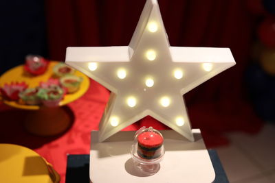 Close-up of illuminated christmas lights on table