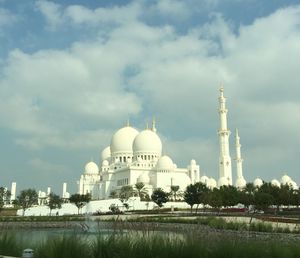 Low angle view of sheikh zayed mosque against cloudy sky