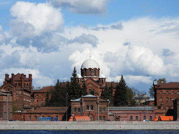 Buildings against cloudy sky