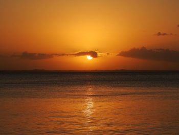 Scenic view of sea against orange sky