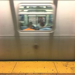 Reflection of train on railroad station platform