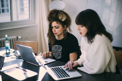 Two people working on table
