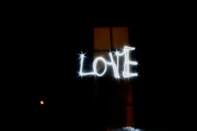 Close-up of illuminated lights against black background