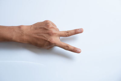 Close-up of human hand against white background